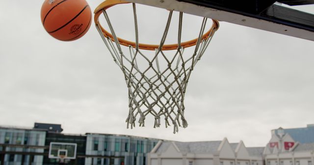 Orange Basketball Flying Towards Hoop On Outdoor Court - Download Free Stock Images Pikwizard.com