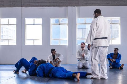 Diverse Martial Arts Class Practicing Sparring with Instructor