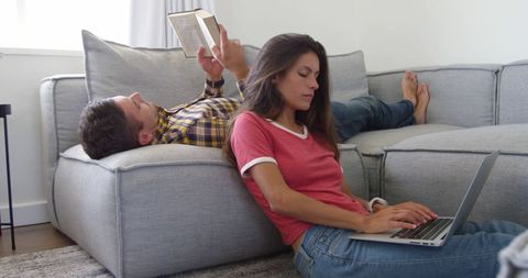 Couple Relaxing at Home with Book and Laptop Showing Work-Life Balance - Download Free Stock Images Pikwizard.com