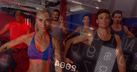 Mixed group fitness class working out with stability balls and dynamic cardio overlay
