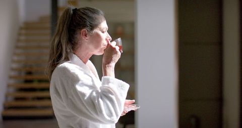 Mature Woman Enjoying Morning Coffee in Sunlit Room