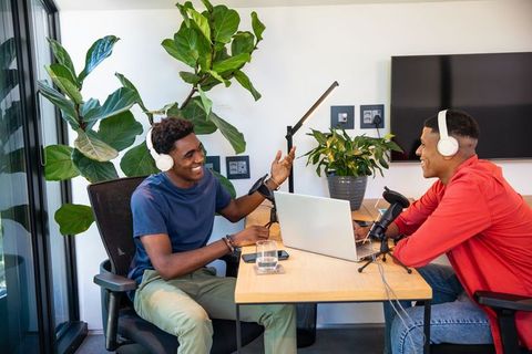 Diverse Podcasters Recording Together in Modern Studio