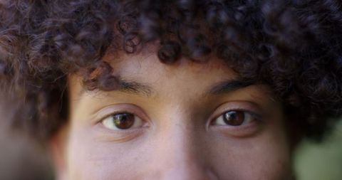 Close-Up of Man with Curly Hair and Natural Expression