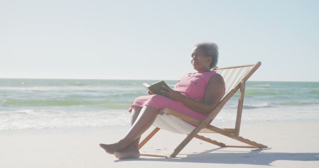 Senior Woman Reading Book on Beach Chair Near Ocean - Download Free Stock Images Pikwizard.com