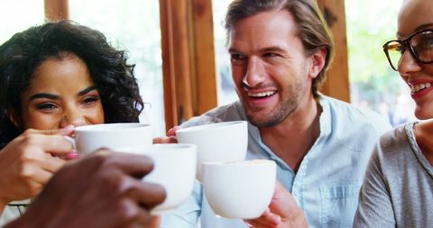 Friends Enjoying Coffee Toast for Unity and Happiness - Download Free Stock Images Pikwizard.com