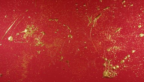 Crimson surface sparkling with gold splatter, metallic glitter and textured impasto