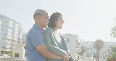 Happy Couple Embracing by Sea on Sunny Day