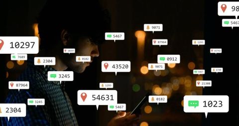 Man holding smartphone at night with floating notifications, location pins and chat alerts