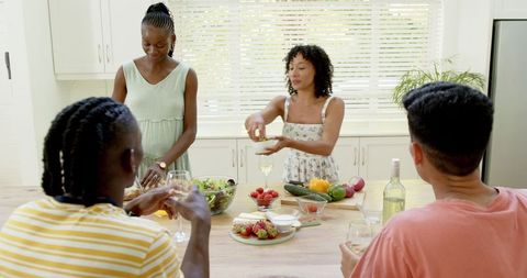 Diverse Friends Engaging in Cooking Together in Modern Kitchen