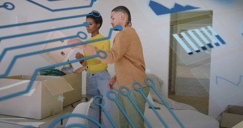 Young couple unpacking boxes in modern living room with digital circuit overlay