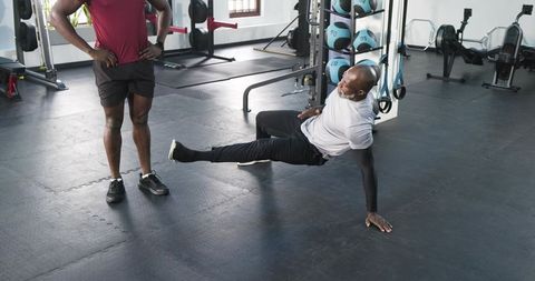 Personal trainer motivating client during strength training session