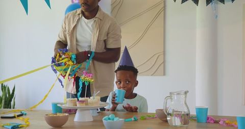 Father and Son Enjoying a Birthday Celebration at Home