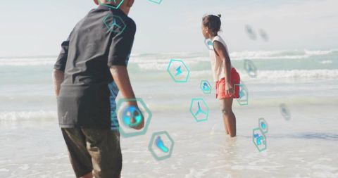 Children wading in ocean with augmented reality hexagon icons, playful beach tech concept