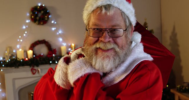 Authentic Santa Claus smiling in festive living room - Download Free Stock Images Pikwizard.com