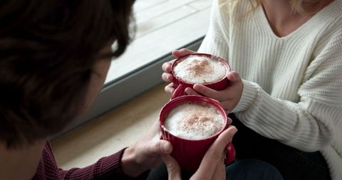 Cozy Moments with Frothy Coffee by Window