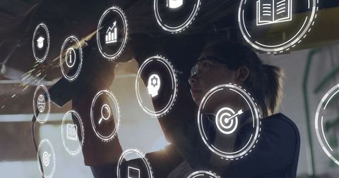 Metalworker using grinder in advanced fabrication workshop