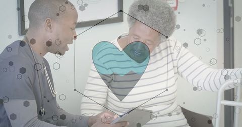 Healthcare professional consulting elderly patient on heart health