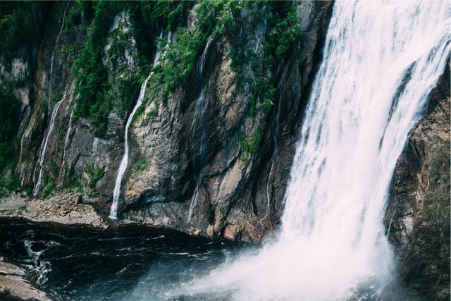 Majestic Waterfall Cascading Down Rocky Cliffside - Download Free Stock Photos Pikwizard.com