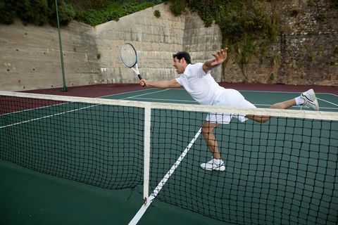 Tennis Player Lunging with Racket on Open Court, Outdoors Determination