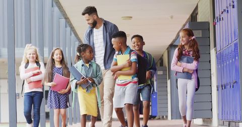 Diverse Teacher Leading Enthusiastic Students in School Hallway - Download Free Stock Images Pikwizard.com