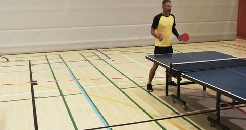 Table Tennis Player Practicing in Indoor Sports Facility