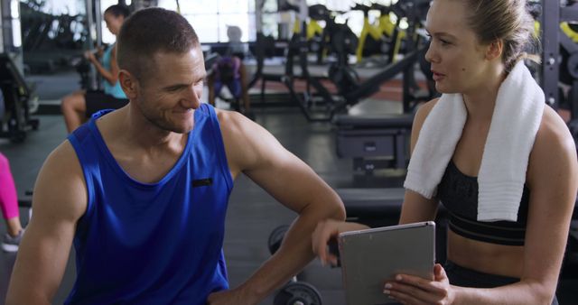 Personal Trainer Consulting with Female Client at Gym on Exercise Plan - Download Free Stock Images Pikwizard.com