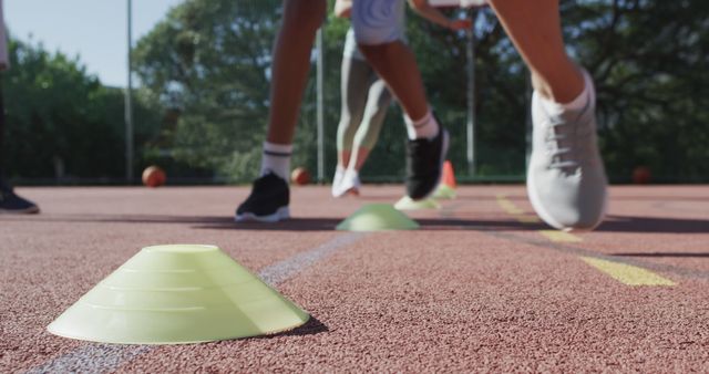 Group of Athletes Training Outdoors with Cones on Track - Download Free Stock Images Pikwizard.com