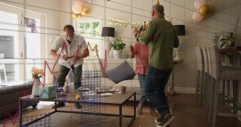 Three friends celebrating birthday at home dancing in cozy living room with balloons