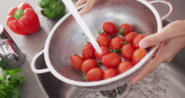 Washing Cherry Tomatoes in Stainless Steel Colander in Kitchen - Download Free Stock Images Pikwizard.com