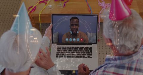 Seniors in festive hats video calling with futuristic tech overlay