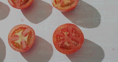 Sliced Cherry Tomatoes Casting Soft Shadows on White Surface with Typographic Overlay