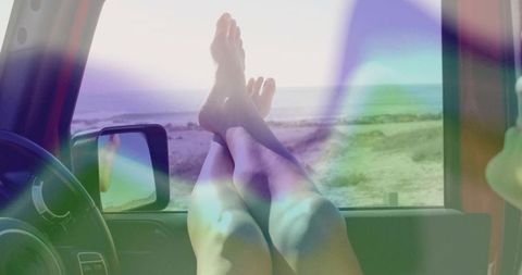 Relaxed Feet Hanging from Car Window at Beachside