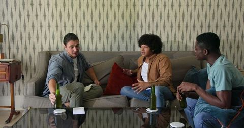 Diverse Group of Friends Socializing and Sharing Drinks at Home