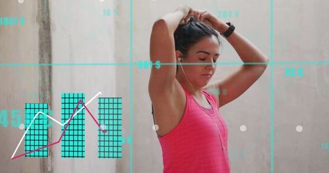 Woman preparing for workout tying hair wearing earphones and smartwatch with data overlay