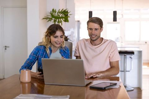 Couple Working from Home at Modern Kitchen Table
