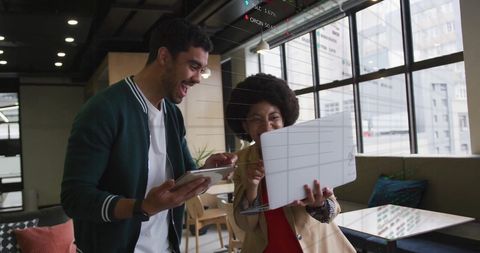 Diverse Colleagues Collaborating on Digital Projects in Modern Office