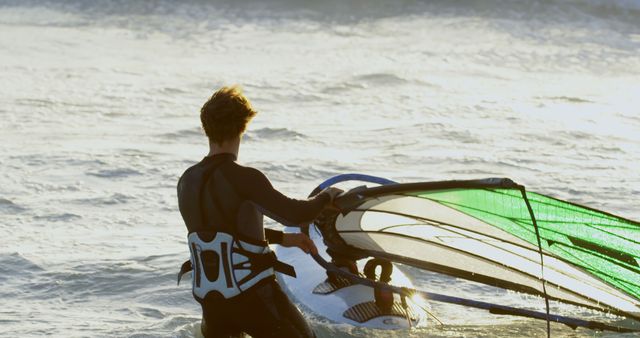 Windsurfer Preparing to Enter Water at Sunset - Download Free Stock Images Pikwizard.com