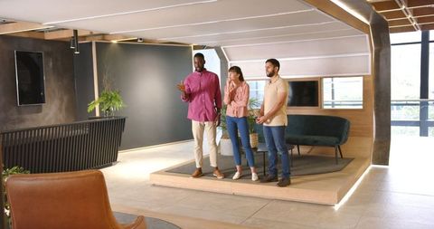 Diverse Team Engaged in Workplace Discussion in Modern Office