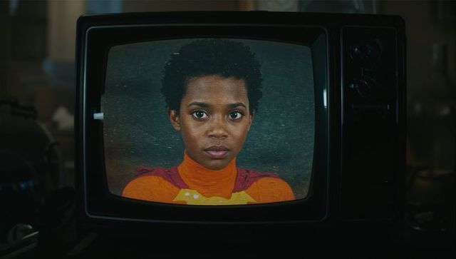 Vintage CRT Television Displaying Child's Face in Dark Workshop