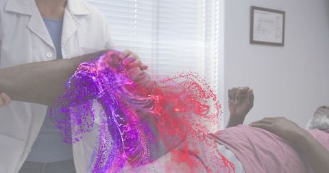 Clinician examining patient leg with purple-red augmented reality therapy visualization