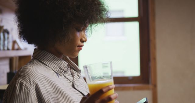 Afro Hair Woman Drinking Healthy Orange Juice by Window - Download Free Stock Images Pikwizard.com