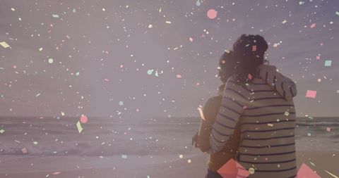 Couple Embracing on Beach at Sunset with Confetti Overlay