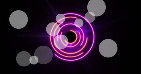 Glowing neon circles and light spots on black background