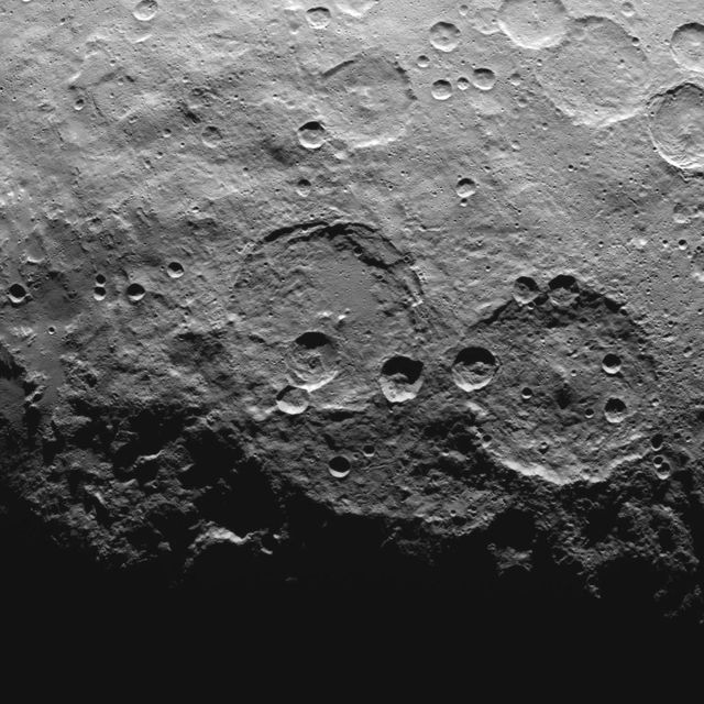 High-resolution image of the southern latitudes on Ceres taken by NASA's Dawn spacecraft, featuring Zadeni crater on the right. Ideal for use in scientific articles, space research presentations, educational materials, and astronomical publications. The image provides valuable insights into crater formation on dwarf planets and is useful for comparative planetary geology studies.