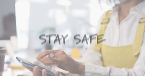 woman disinfecting smartphone with safety message overlay - Download Free Stock Images Pikwizard.com