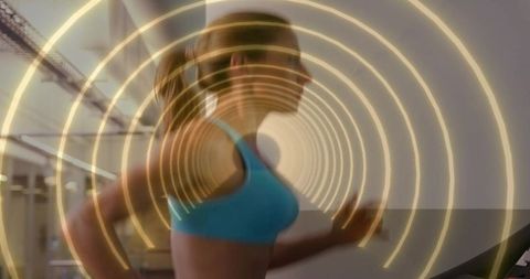 Athletic woman running on treadmill with futuristic concentric light rings for cardio