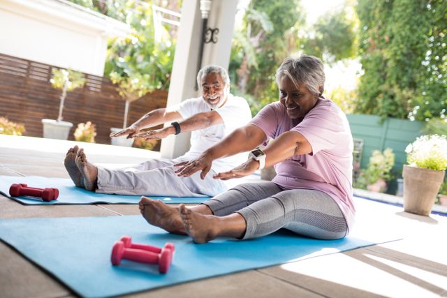 Full length of senior couple doing stretching exercise - Download Free Stock Photos Pikwizard.com
