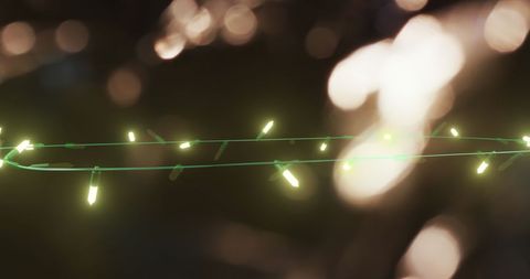 Flickering fairy lights against spot of light background