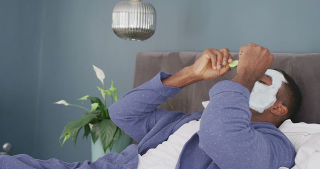 Man Enjoying Face Mask and Cucumber Slices, Relaxing in Comfort - Download Free Stock Images Pikwizard.com