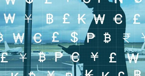 International currency symbols with businessman at airport